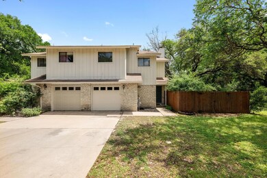 View of front of home with a garage, a chimney, d