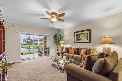Living room featuring a water view, ceiling fan, o
