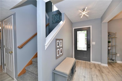 Stairwell and spacious coat closet just inside the front door