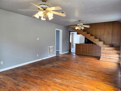 open living/kitchen stairs leading to bonus room and bath upstairs