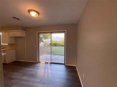 Unfurnished dining area with sink and a textured c