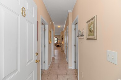 Corridor featuring light tile floors