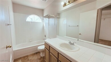 Full bathroom with tiled shower / bath combo, vani