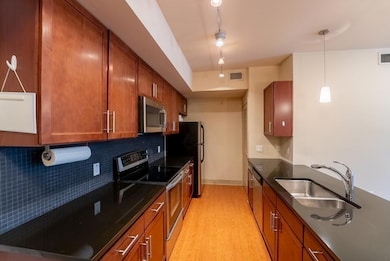Kitchen with light wood-style flooring, a sink, b