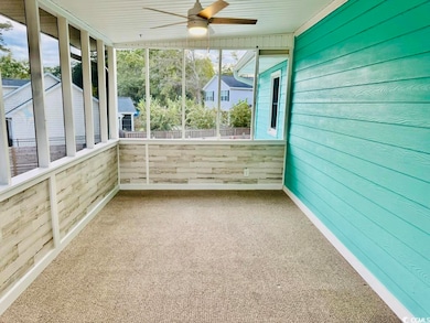 Unfurnished sunroom featuring ceiling fan