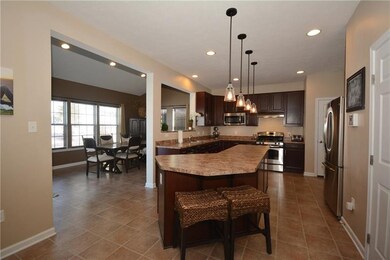 The kitchen island has a overhang for seating and 