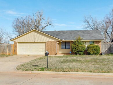 Ranch-style home featuring a front yard and a gara