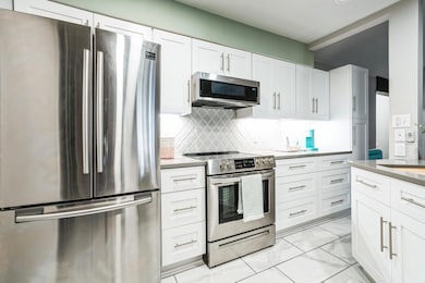 Kitchen with marble finish floor, appliances with