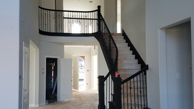 dramatic view of stairs and catwalk open to family room and entry