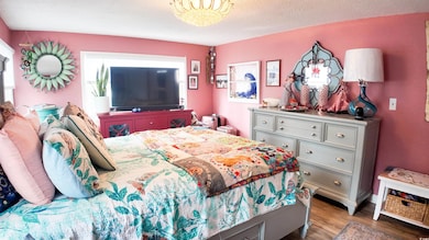 Bedroom with a textured ceiling and wood finished 