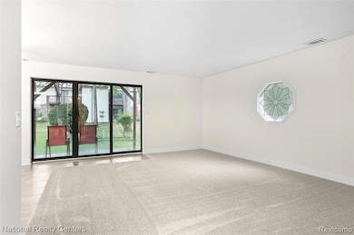 Empty room with baseboards and light carpet