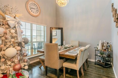 Dining room featuring a notable chandelier, dark wood-type flooring, and a wealth of natural light