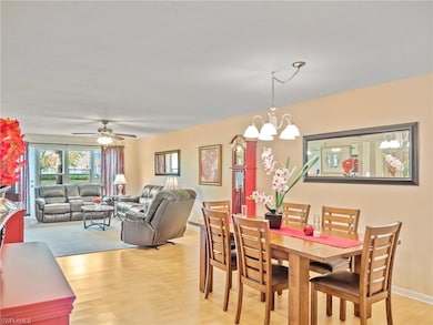Dining space featuring light wood-style floors, a chandelier, and ceiling fan