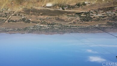 STANDING ON PROPERTY FACING MORENO VALLEY