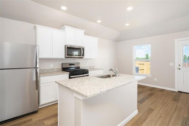 The granite countertops and modern white cabinetry are