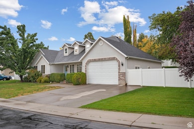 Traditional home featuring stucco siding, concrete driveway, covered porch, a shingled roof, and an attached garage