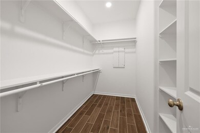 Spacious closet featuring wood finish floors