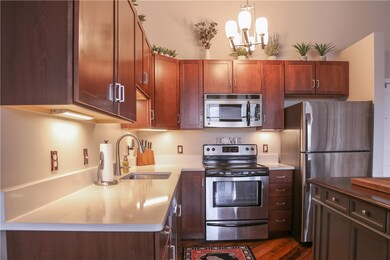 The kitchen has stainless appliances and beautiful
