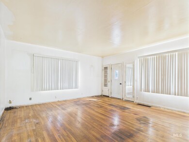 Unfurnished room featuring wood-type flooring and baseboards