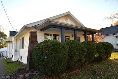 View of front of home featuring a porch and a garage