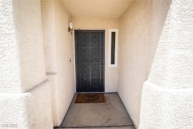 Entrance to property with stucco siding