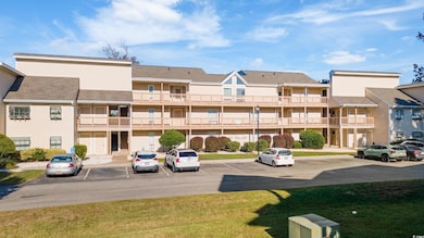 View of property with uncovered parking