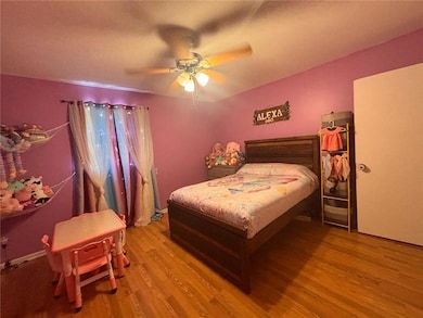 Bedroom featuring wood finished floors and a ceiling fan