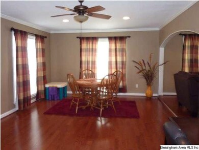 Arched doorways connect the living room and den