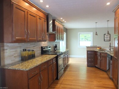 Kitchen has granite countertops, stainless steel a