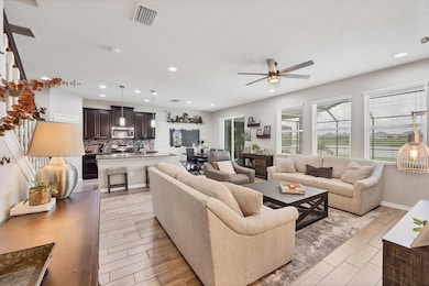 Great room open to kitchen with soft neutral colors