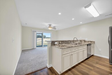 Kitchen with white cabinets, wood-type flooring, s