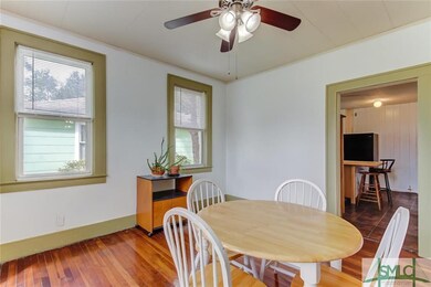 Wood floors continue into the dining room which is