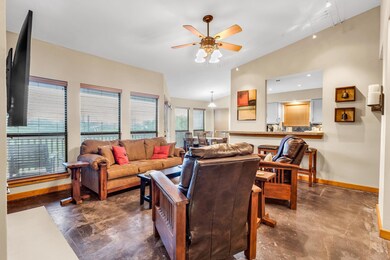 Living room with rail lighting, ceiling fan, base