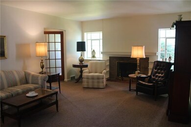 Large living room with a wood burning fireplace wi