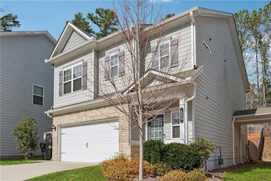 View of front of home with concrete driveway, an a