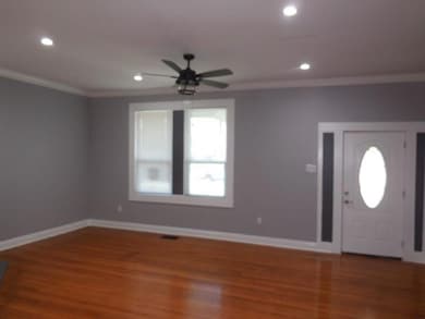Foyer featuring wood finished floors, ceiling fan,