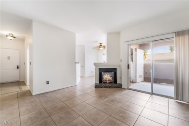 Unfurnished living room featuring light tile patte
