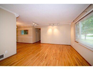 View of living room from entrance with large sunny