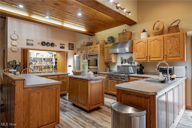 Gormet Kitchen, With Custom Hand Made Solid Oak Cabinets, Premium Stainless Stell Appliances, Premium LVT Flooring, Breakfast Bar, Large Pantry, French Doors to Deck, Custom Lighting