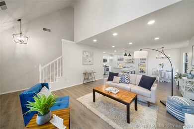 Living Room with View of Stairway, Dining, and Kit