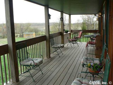 Other Front Porch overlooking the pond and acreage