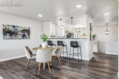 Dining area with dark hardwood / wood-style floors