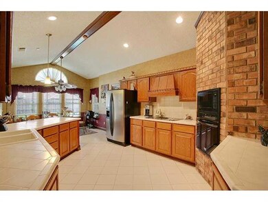 Kitchen. Nice title counter tops with brick wall a
