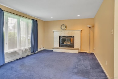 Walk-in to this cozy Living Room with fireplace.