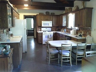 Kitchen features glass front cabinet over buffet c
