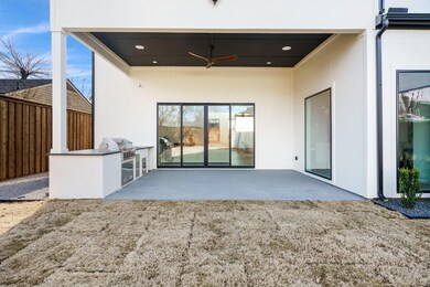 Back of house with an outdoor kitchen, ceiling fan