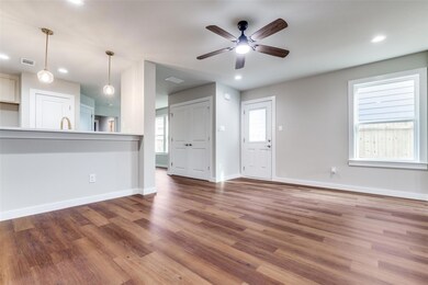 Unfurnished living room with baseboards, visible v