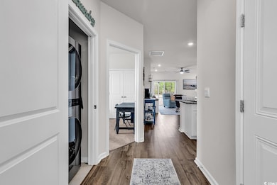 Hall featuring baseboards, dark wood-style floors,