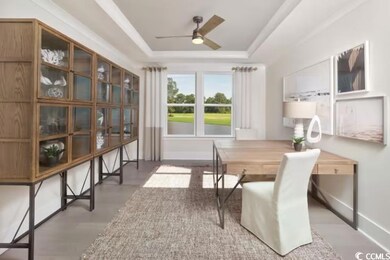 Office featuring baseboards, a ceiling fan, and a 