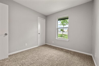 Carpeted spare room with baseboards
